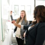 Women writing on a marker board